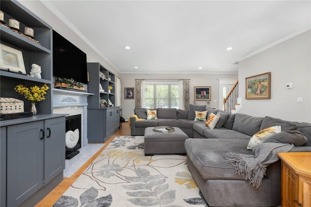 114 Teaberry Dr, Tiverton, RI 02878 - living area featuring light wood-style floors, a fireplace, ornamental molding, recessed lighting, and stairway