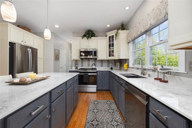114 Teaberry Dr, Tiverton, RI 02878 - kitchen with appliances with stainless steel finishes, a sink, recessed lighting, white cabinetry, and glass insert cabinets