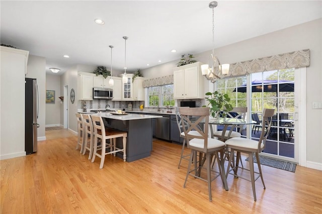 114 Teaberry Dr, Tiverton, RI 02878 - dining space featuring a chandelier, light wood-style floors, baseboards, and recessed lighting