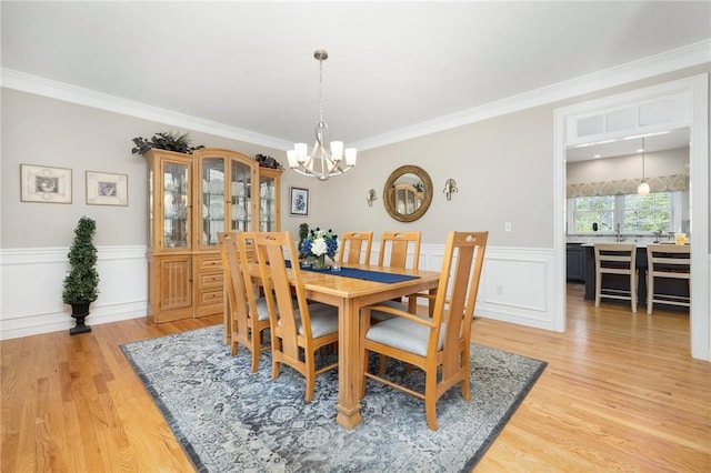 114 Teaberry Dr, Tiverton, RI 02878 - dining area featuring a chandelier, a wainscoted wall, light wood-type flooring, and ornamental molding