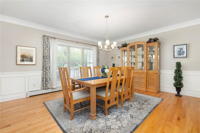 114 Teaberry Dr, Tiverton, RI 02878 - dining space featuring a chandelier, crown molding, wainscoting, and light wood-style flooring