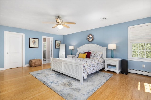 114 Teaberry Dr, Tiverton, RI 02878 - bedroom featuring wood finished floors, baseboards, a ceiling fan, and a baseboard heating unit