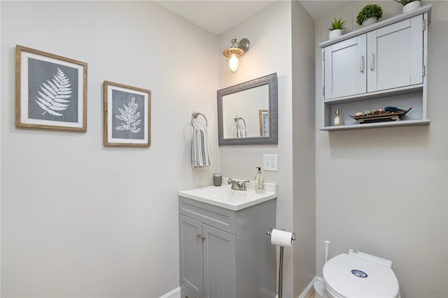 114 Teaberry Dr, Tiverton, RI 02878 - half bathroom with vanity, baseboards, and toilet