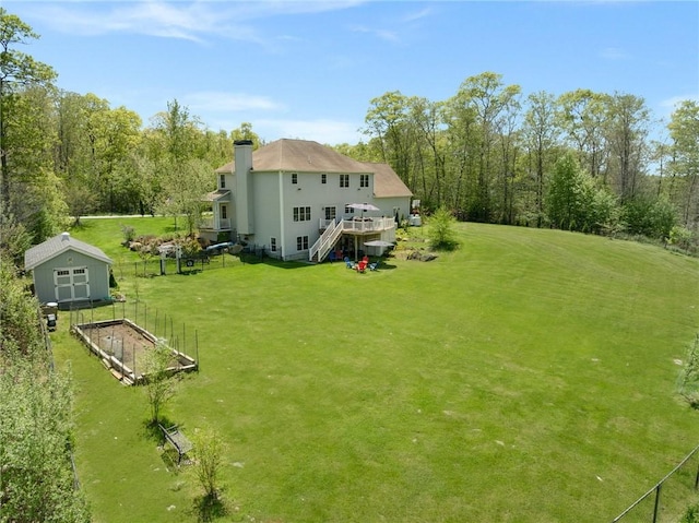 114 Teaberry Dr, Tiverton, RI 02878 - back of property featuring a garden, a yard, a wooden deck, a chimney, and stairs