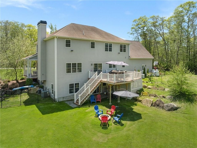 114 Teaberry Dr, Tiverton, RI 02878 - rear view of house with a chimney, stairs, an outdoor fire pit, and a wooden deck