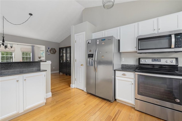 299 S Christopher Ave, Tiverton, RI 02878 - kitchen with appliances with stainless steel finishes, lofted ceiling, light wood-type flooring, white cabinets, and dark countertops