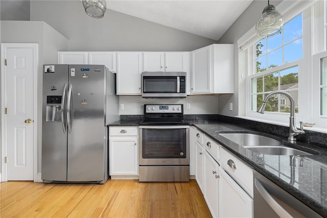 299 S Christopher Ave, Tiverton, RI 02878 - kitchen featuring stainless steel appliances, a sink, vaulted ceiling, white cabinetry, and dark stone countertops