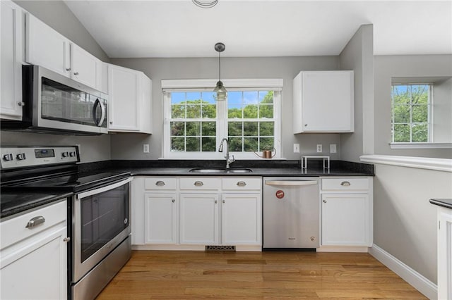 299 S Christopher Ave, Tiverton, RI 02878 - kitchen with appliances with stainless steel finishes, a sink, white cabinetry, dark countertops, and vaulted ceiling