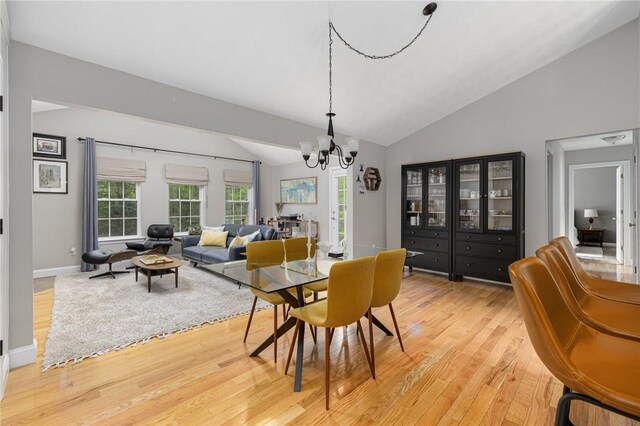 299 S Christopher Ave, Tiverton, RI 02878 - dining area with lofted ceiling, light wood-style floors, a chandelier, and baseboards