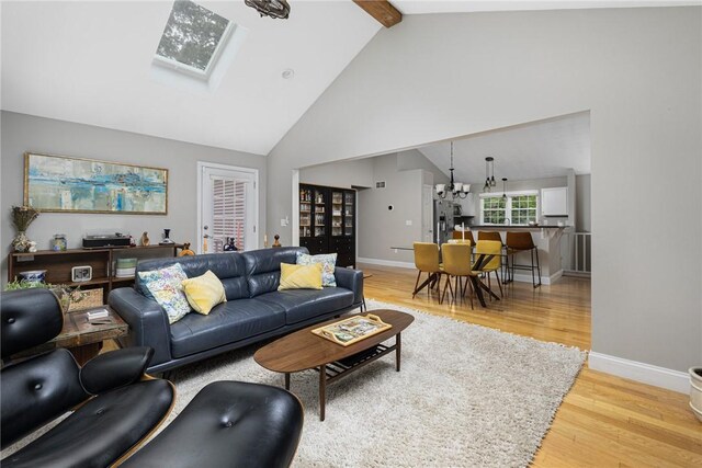 299 S Christopher Ave, Tiverton, RI 02878 - living area featuring light wood-style floors, high vaulted ceiling, baseboards, beamed ceiling, and a chandelier