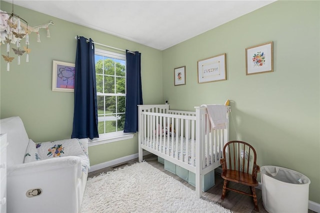 299 S Christopher Ave, Tiverton, RI 02878 - bedroom featuring wood finished floors, baseboards, and a nursery area