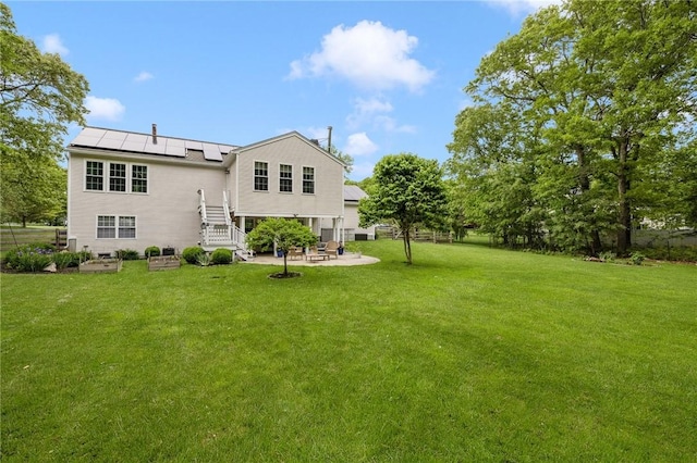 299 S Christopher Ave, Tiverton, RI 02878 - back of property featuring solar panels, a patio, and a yard
