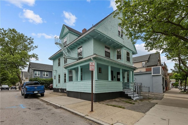1413 Broad St, Providence, RI 02905 - view of front of home featuring covered porch and a chimney