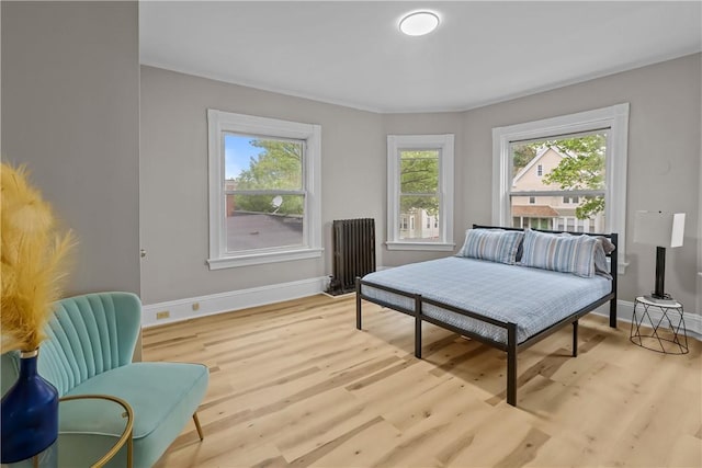 1413 Broad St, Providence, RI 02905 - bedroom with baseboards, radiator heating unit, and wood finished floors