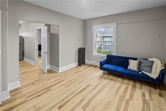 1413 Broad St, Providence, RI 02905 - sitting room with radiator heating unit, wood finished floors, and baseboards