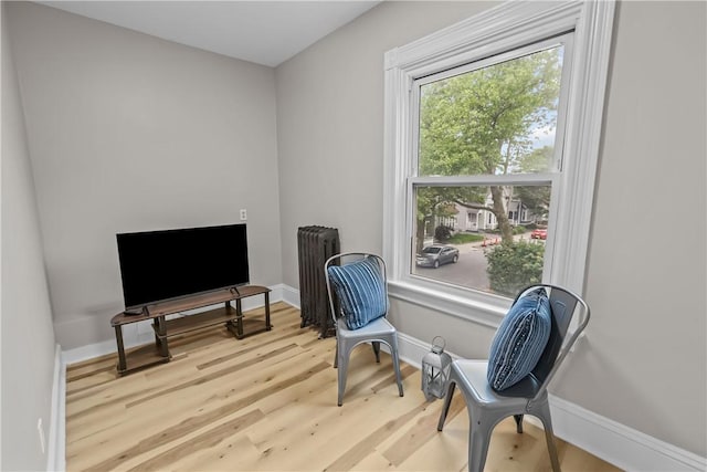 1413 Broad St, Providence, RI 02905 - sitting room with baseboards, wood finished floors, and radiator heating unit