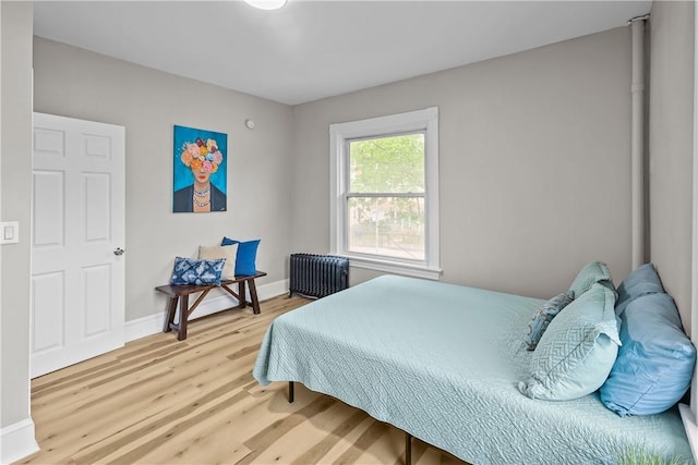 1413 Broad St, Providence, RI 02905 - bedroom featuring radiator heating unit, wood finished floors, and baseboards