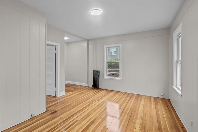 1413 Broad St, Providence, RI 02905 - empty room featuring radiator heating unit, light wood finished floors, and baseboards