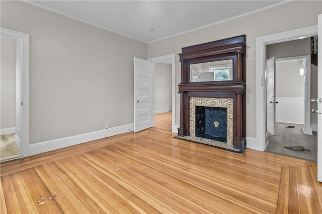 1413 Broad St, Providence, RI 02905 - unfurnished living room featuring ornamental molding, baseboards, a tiled fireplace, and wood finished floors