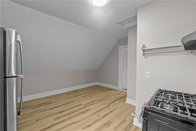1413 Broad St, Providence, RI 02905 - kitchen with freestanding refrigerator, lofted ceiling, light wood-style flooring, black range with gas cooktop, and baseboards