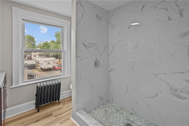 1413 Broad St, Providence, RI 02905 - bathroom featuring radiator heating unit, a marble finish shower, vanity, wood finished floors, and toilet