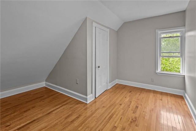 1413 Broad St, Providence, RI 02905 - bonus room featuring lofted ceiling, light wood-type flooring, and baseboards