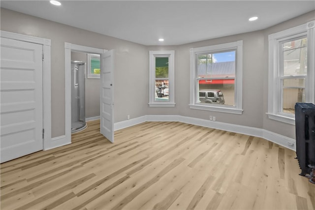 1413 Broad St, Providence, RI 02905 - unfurnished living room featuring light wood-type flooring, baseboards, and recessed lighting