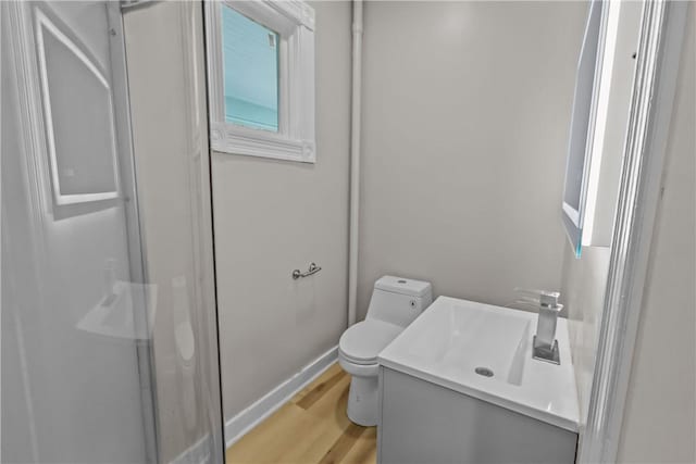 1413 Broad St, Providence, RI 02905 - bathroom with vanity, toilet, wood finished floors, baseboards, and a shower