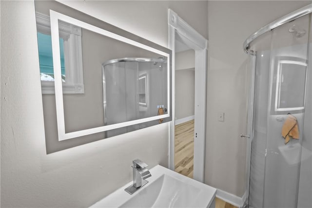1413 Broad St, Providence, RI 02905 - bathroom featuring a shower stall, a sink, and wood finished floors