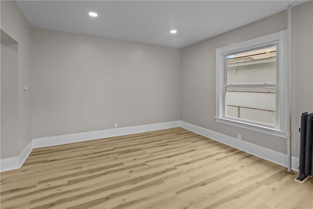 1413 Broad St, Providence, RI 02905 - spare room featuring light wood-style flooring, baseboards, radiator, and recessed lighting