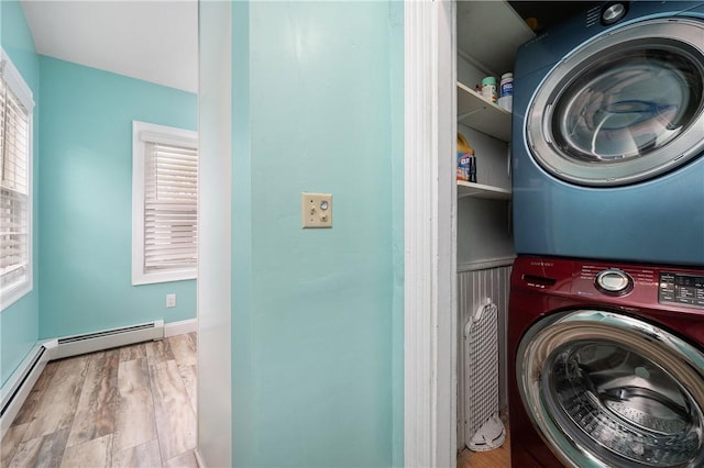 130 Alice Ave, Woonsocket, RI 02895 - laundry room featuring estacked washer and dryer, wood finished floors, and a baseboard heating unit