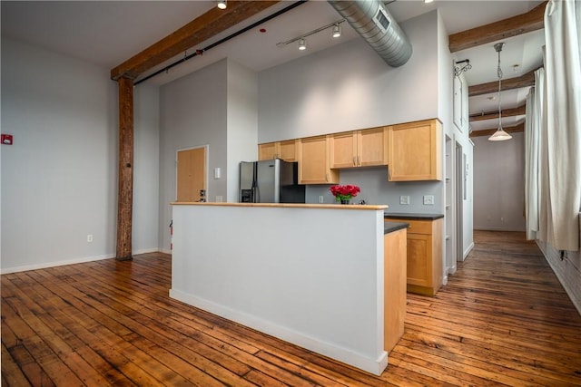 28 Bayley St Unit 304, Pawtucket, RI 02860 - kitchen with stainless steel fridge, light brown cabinetry, a towering ceiling, beamed ceiling, and track lighting