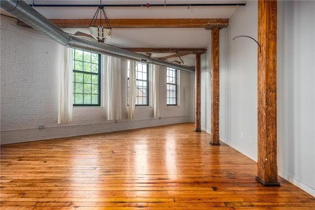 28 Bayley St Unit 304, Pawtucket, RI 02860 - unfurnished room with brick wall, wood-type flooring, and beamed ceiling