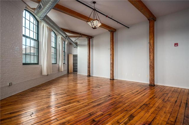 28 Bayley St Unit 304, Pawtucket, RI 02860 - spare room with beamed ceiling, brick wall, wood-type flooring, and baseboards