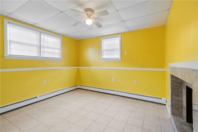 9 Melody Ln, Johnston, RI 02919 - spare room featuring a ceiling fan, a drop ceiling, baseboard heating, and a fireplace