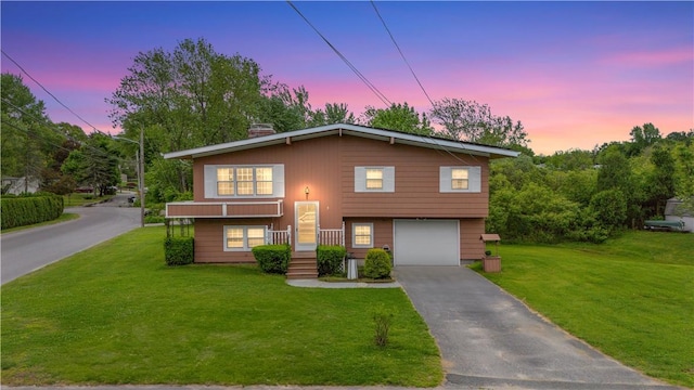 9 Melody Ln, Johnston, RI 02919 - view of front of home featuring an attached garage, a front lawn, and asphalt driveway