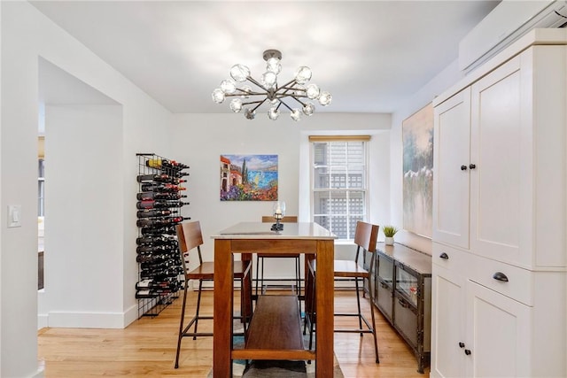 75 Pelham St Unit A, Newport, RI 02840 - dining room featuring a chandelier, light wood-style floors, and baseboards