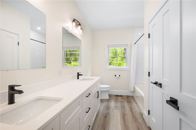 1332 S Rd, South Kingstown, RI 02879 - full bath featuring double vanity, wood finished floors, toilet, shower / bath combo with shower curtain, and baseboards