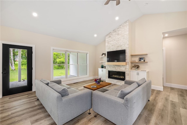 1332 S Rd, South Kingstown, RI 02879 - living area featuring plenty of natural light, a stone fireplace, high vaulted ceiling, light wood-style floors, and recessed lighting