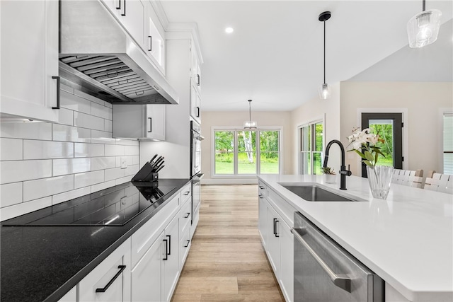 1332 S Rd, South Kingstown, RI 02879 - kitchen with a sink, exhaust hood, stainless steel appliances, light wood finished floors, and white cabinets