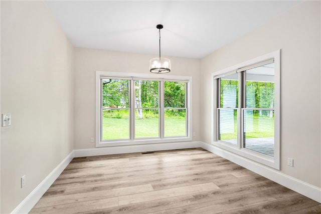1332 S Rd, South Kingstown, RI 02879 - unfurnished dining area featuring a chandelier, baseboards, and light wood-style flooring