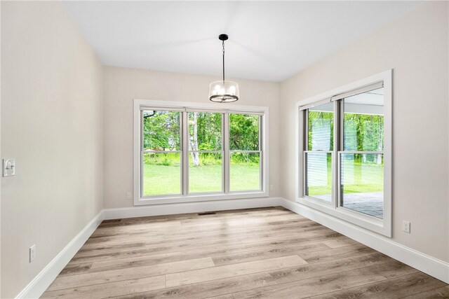 1332 S Rd, South Kingstown, RI 02879 - unfurnished dining area featuring a chandelier, baseboards, and light wood-style floors
