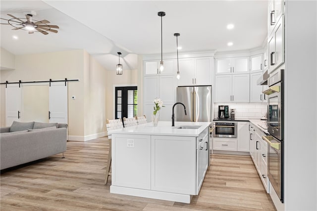 1332 S Rd, South Kingstown, RI 02879 - kitchen with open floor plan, a sink, light wood finished floors, baseboards, and recessed lighting