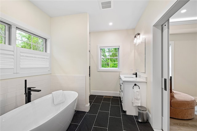 1332 S Rd, South Kingstown, RI 02879 - full bath with vanity, a soaking tub, tile patterned floors, recessed lighting, and baseboards