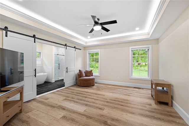 1332 S Rd, South Kingstown, RI 02879 - living area with a barn door, a raised ceiling, light wood-type flooring, ceiling fan, and ornamental molding