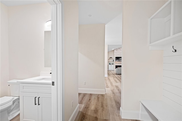 1332 S Rd, South Kingstown, RI 02879 - hall featuring light wood finished floors, baseboards, and a sink