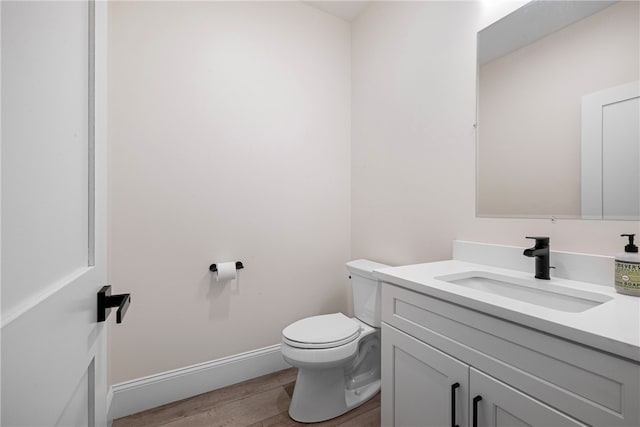 1332 S Rd, South Kingstown, RI 02879 - bathroom featuring toilet, wood finished floors, vanity, and baseboards