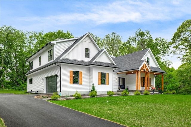 1332 S Rd, South Kingstown, RI 02879 - modern inspired farmhouse featuring covered porch, an attached garage, a front lawn, and asphalt driveway