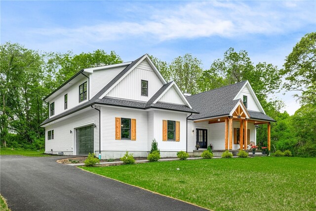 1332 S Rd, South Kingstown, RI 02879 - modern inspired farmhouse featuring a porch, an attached garage, a front lawn, and asphalt driveway