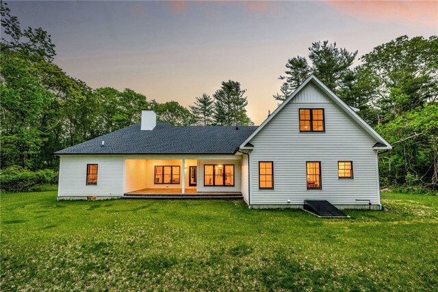 1332 S Rd, South Kingstown, RI 02879 - rear view of house with a yard, a chimney, a porch, and view of scattered trees